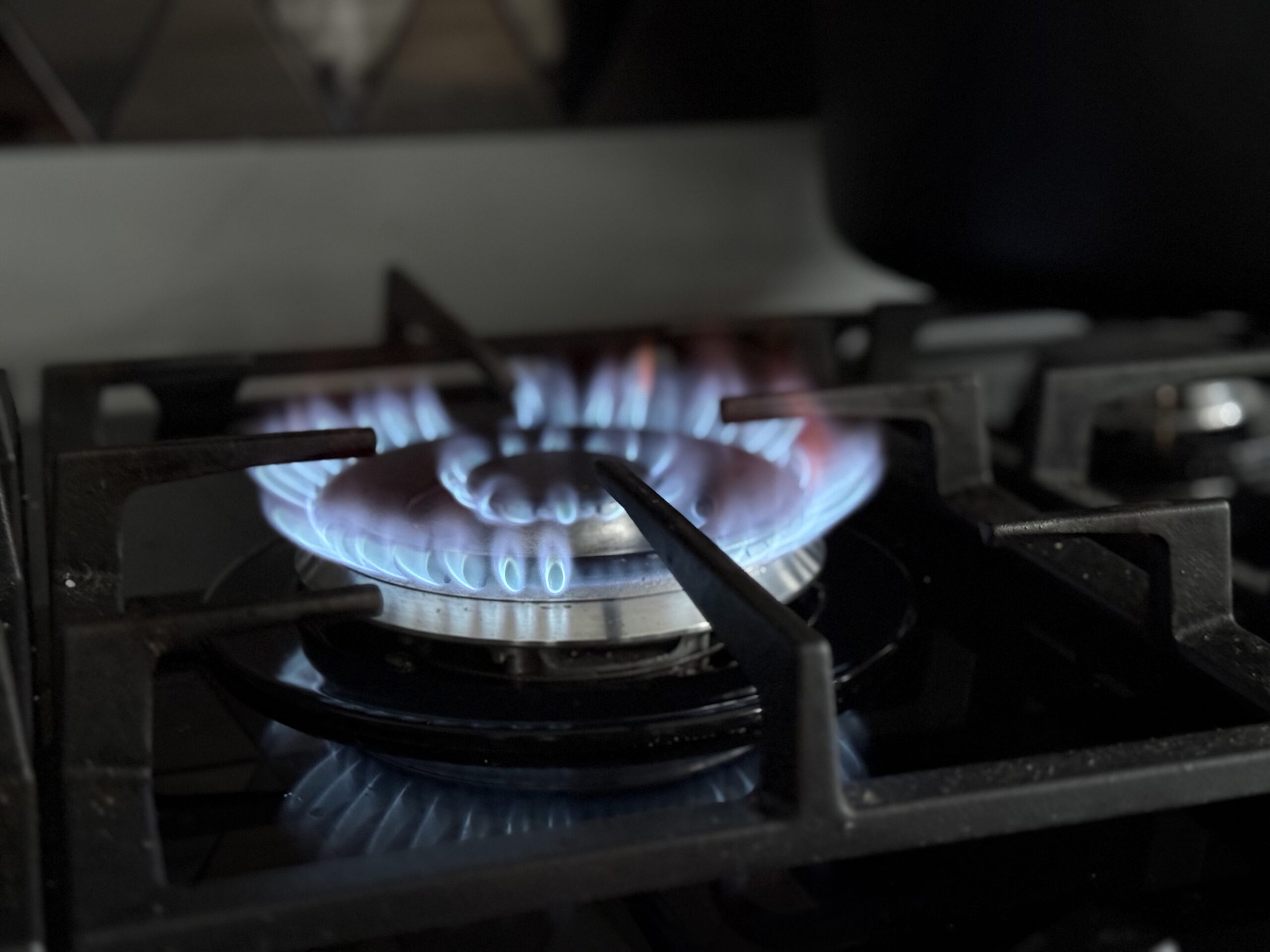 A lit gas hob on a cooker