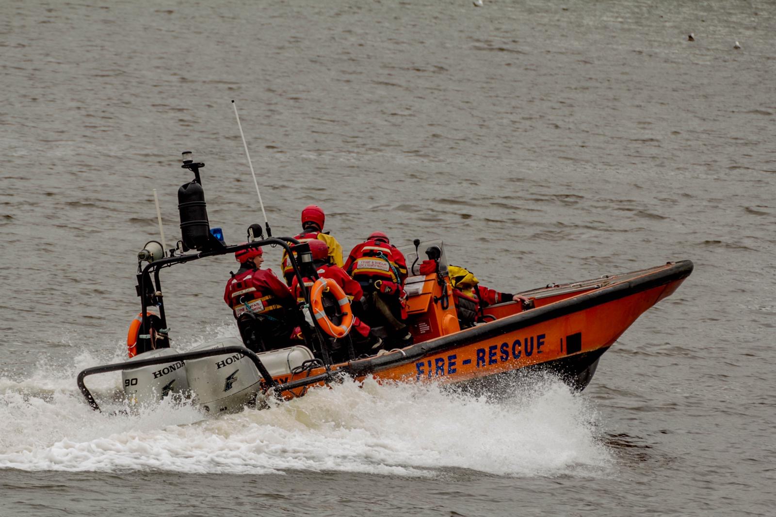 Photograph of the fire boat in the river tyne with firefighters