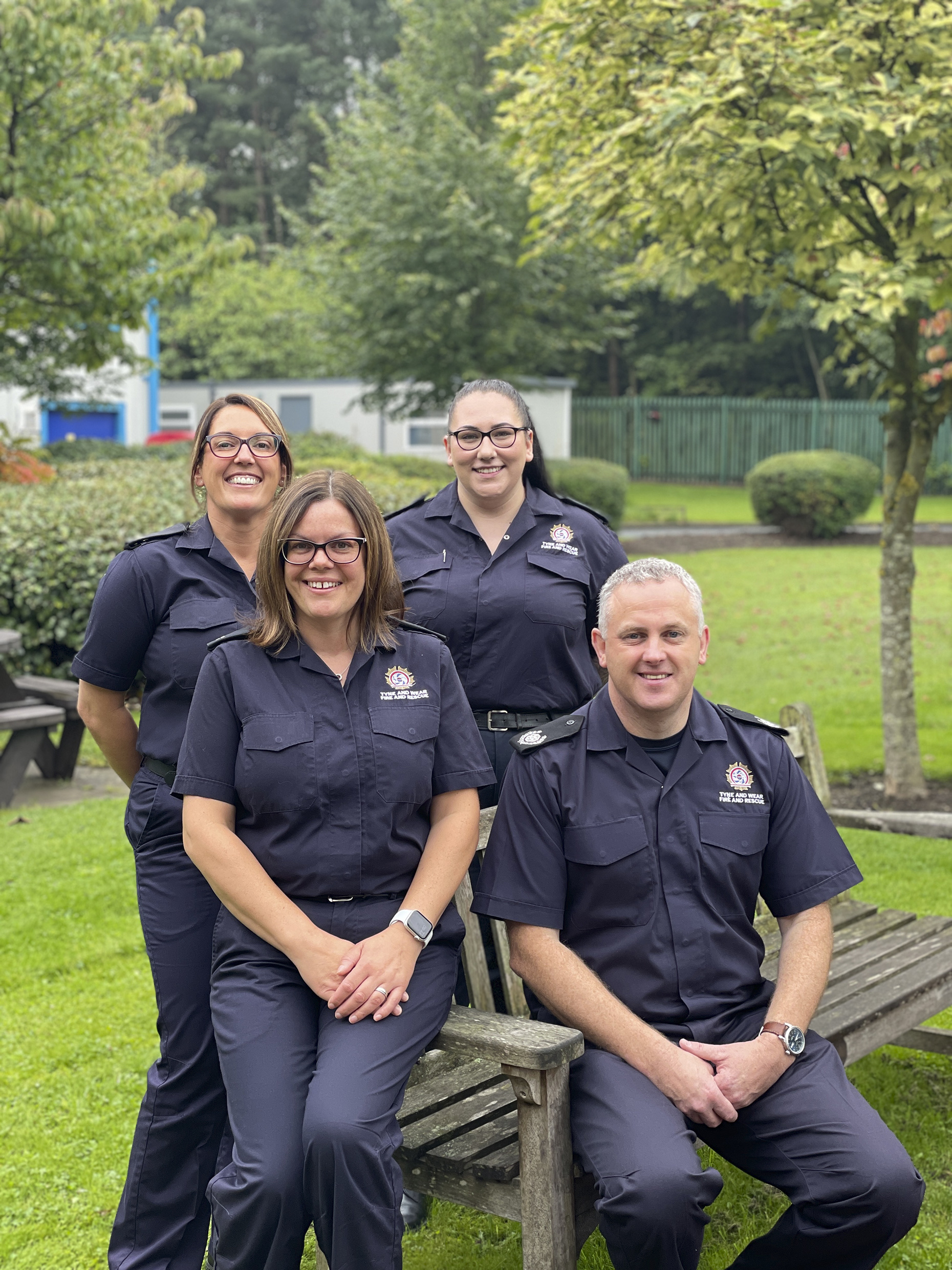 Photograph of four tyne and wear fire and rescue service members of staff smiling