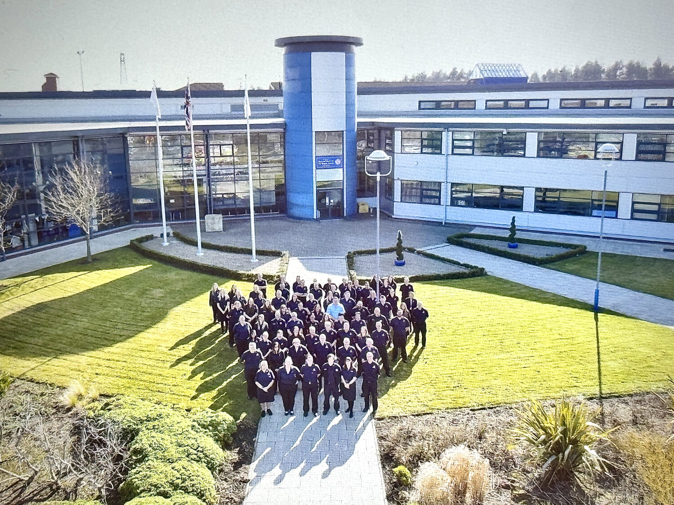 Photograph of staff outside headquarters building