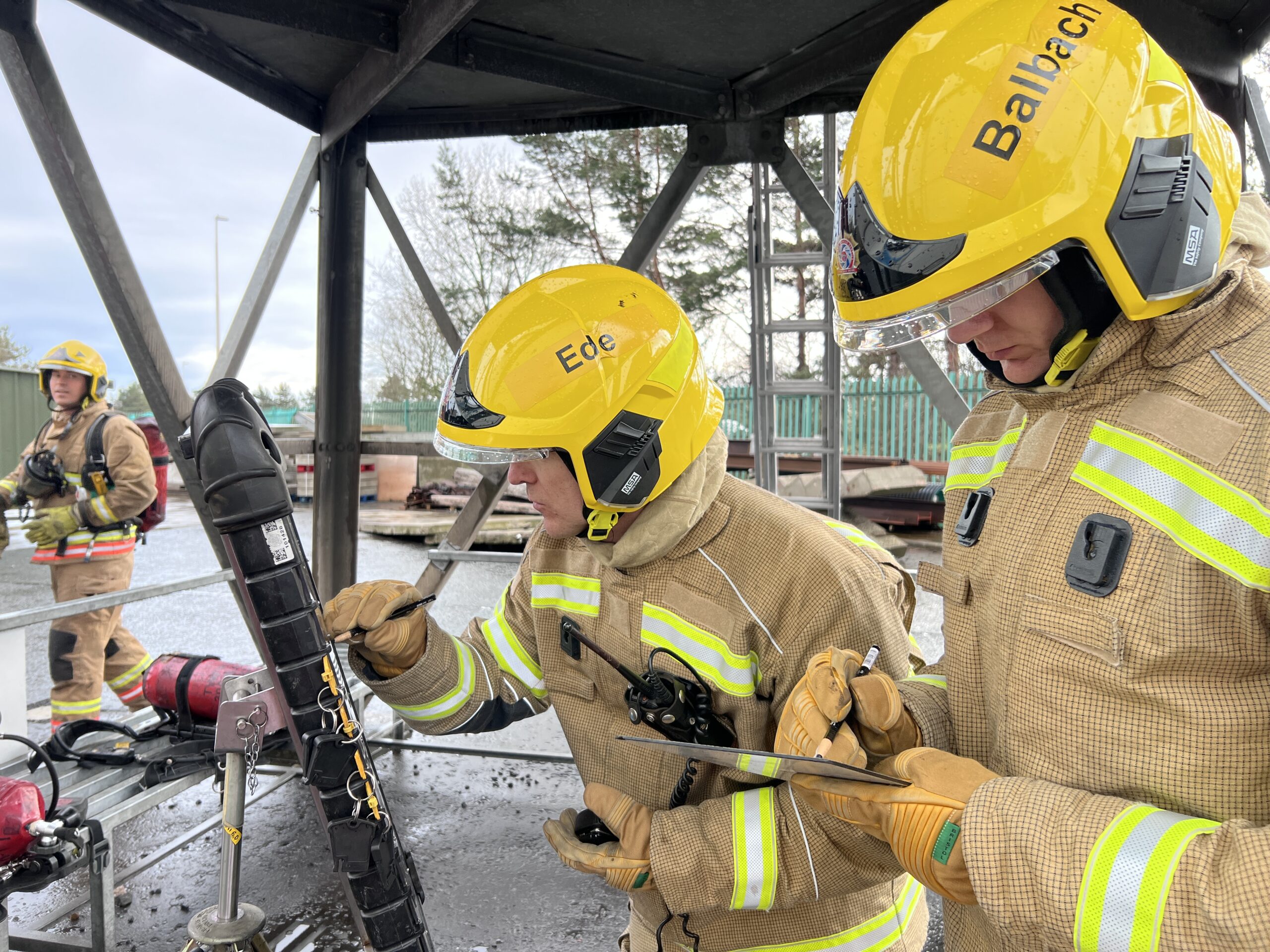 Photograph of two firefighters at work