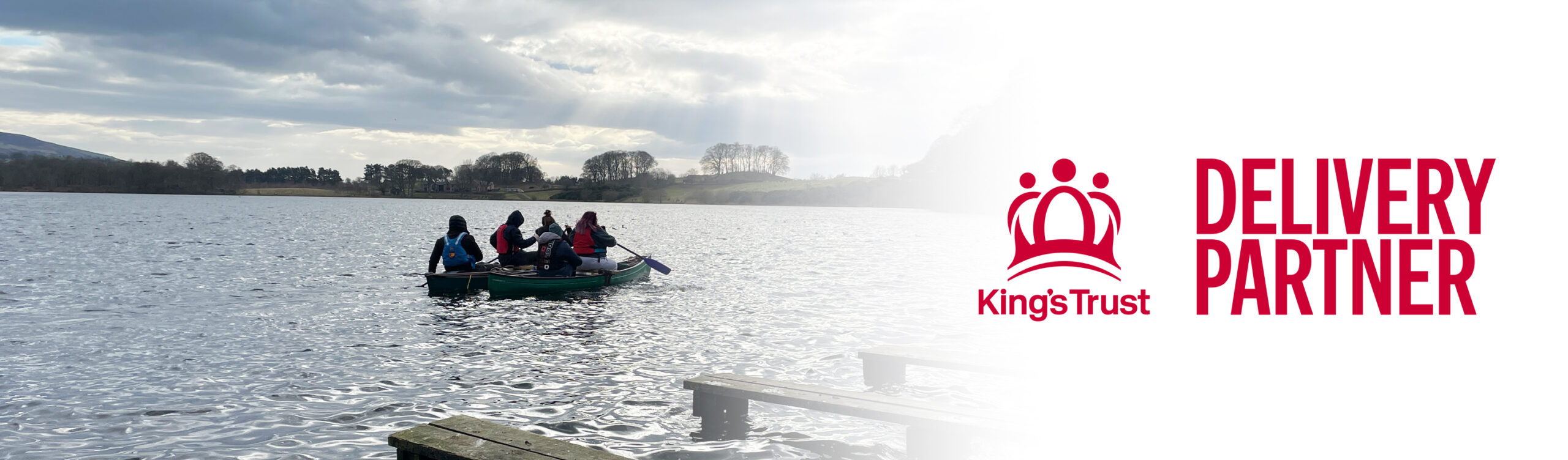 photograph of young people in a boat on the lake as part of kings trust