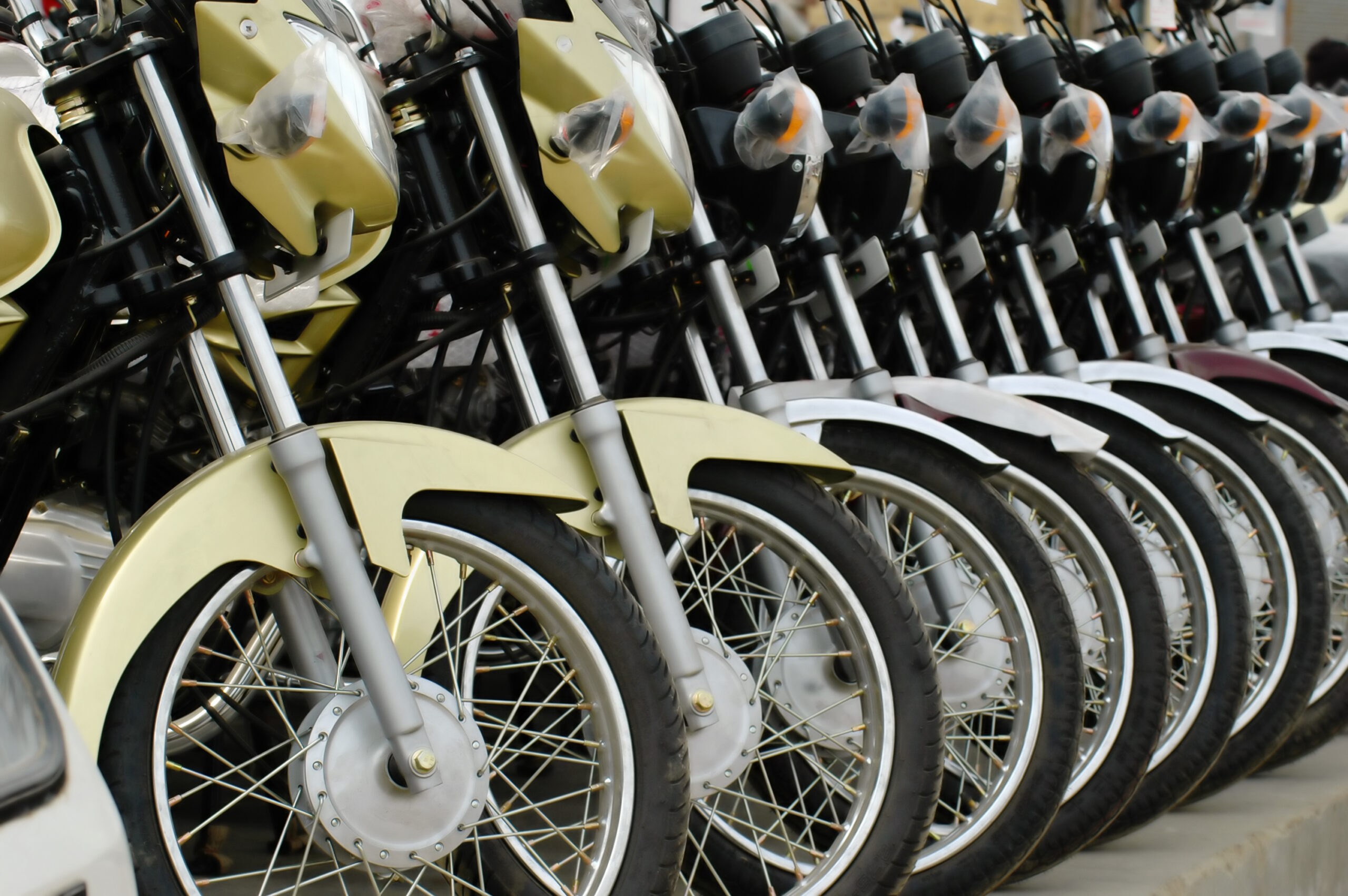 A row of motorbikes on display all in a row.